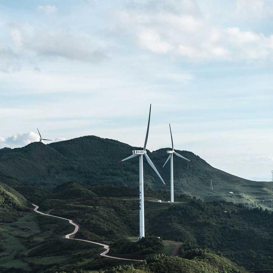 		Wind turbines in a green, hilly landscape
	