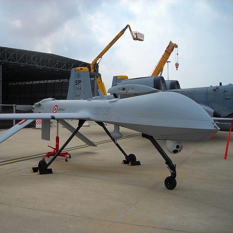 		military drone parked on the ground
	