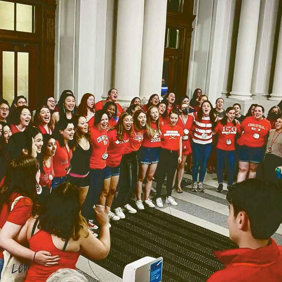 		people singing in Goldwin Smith Hall
	