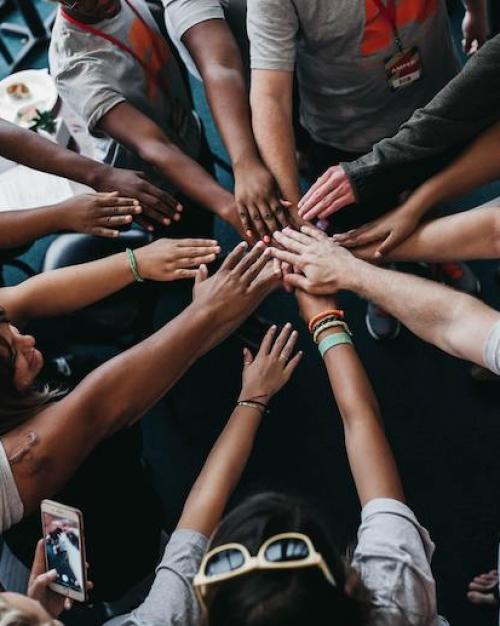 		People placing their hands together in a circle
	