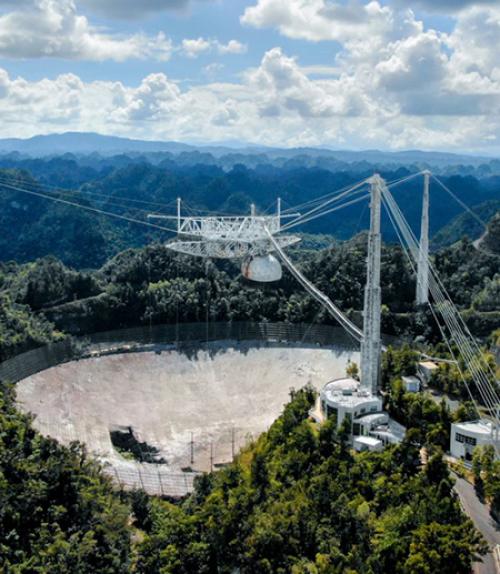 		 Large concrete dish set in lush hills
	