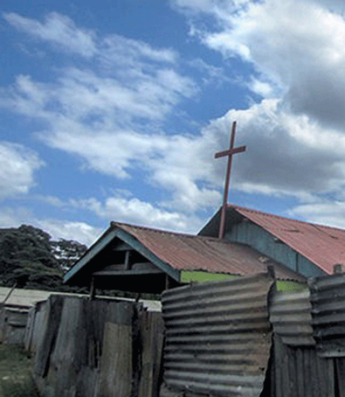 		 A cross above a church roof
	