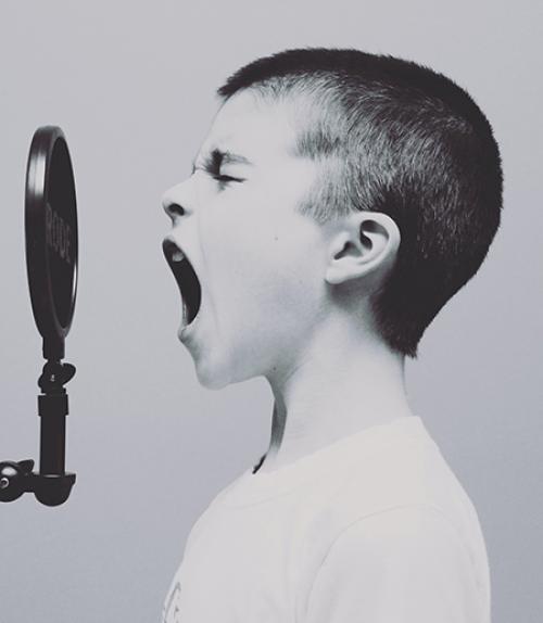 		 Young person, talking into microphone
	