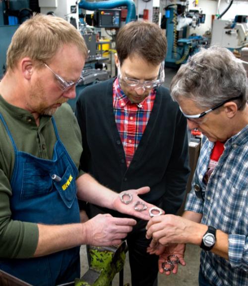 		 faculty looking at parts
	