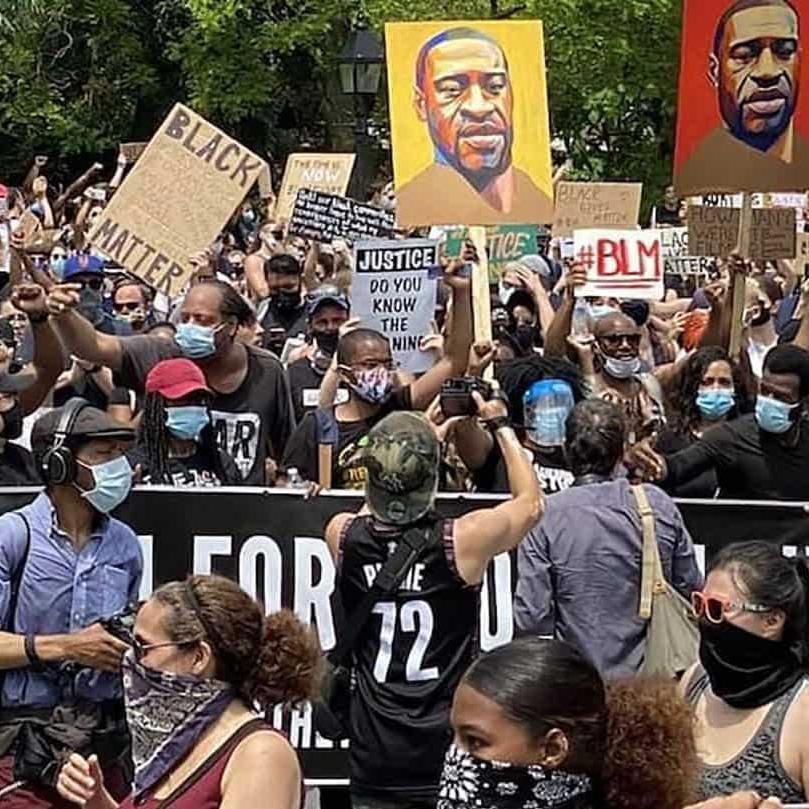 		Crowd of people holding signs during BLM protest
	