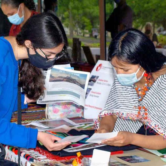 		two women looking at papers
	