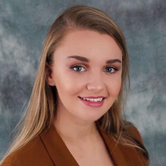 		woman in brown blazer
	