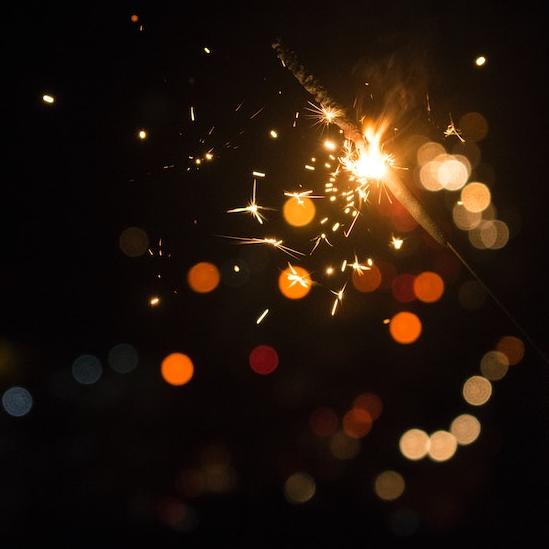 		Spots of orange light against a dark background
	