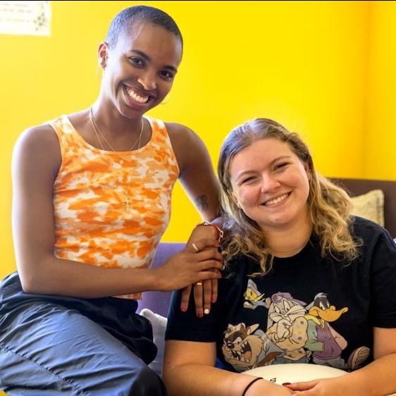 		Three people in a sunny room with yellow walls
	