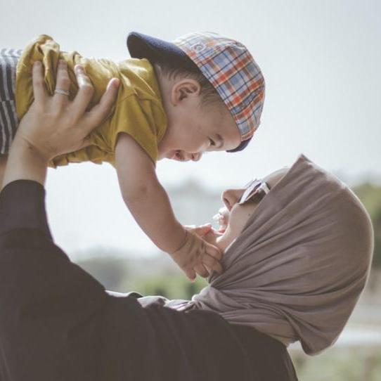 		Person holds baby up in the air
	