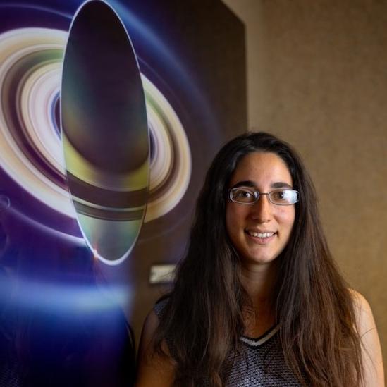 		Person standing in front of a small space craft
	