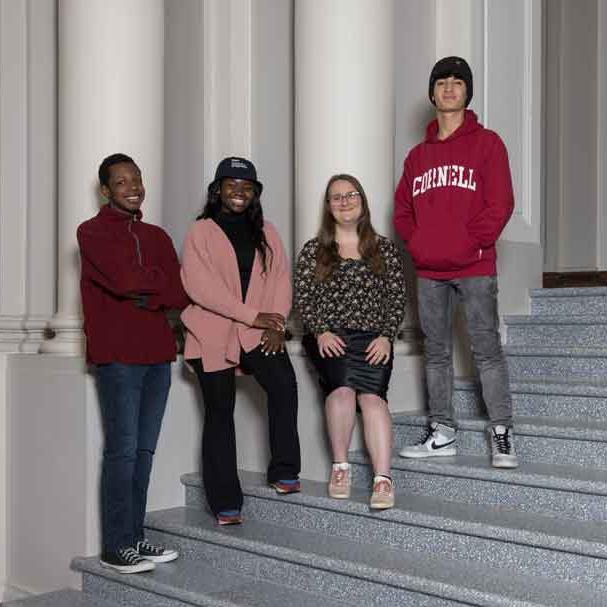 		four students on stairs 
	