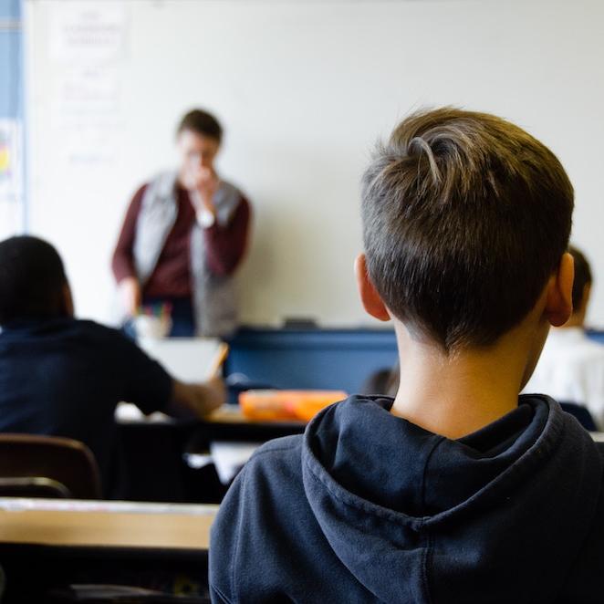 		Students in a classroom, seen from behind
	