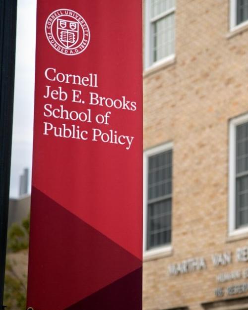 		red banner hanging outside a brick building
	