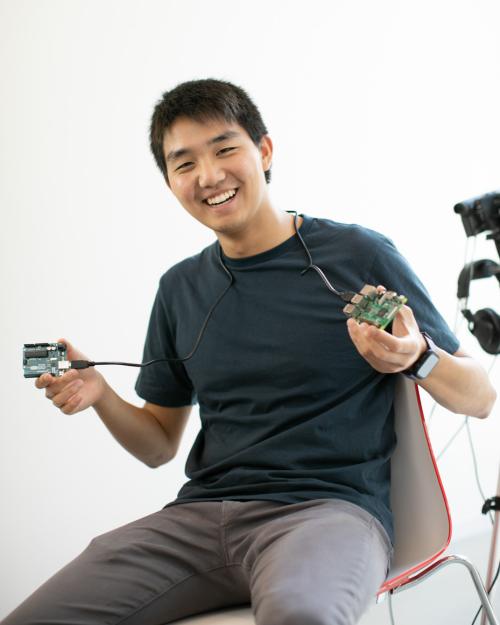 person holding two black things