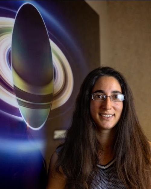 		Person standing in front of a small space craft
	