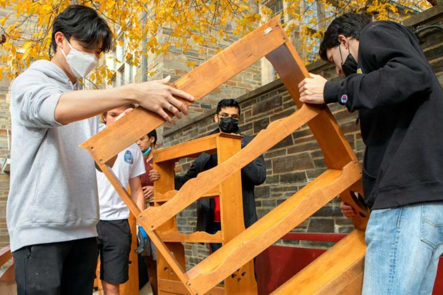 students moving furniture