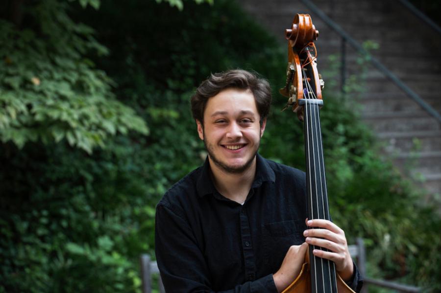 Person holding a string bass instrument