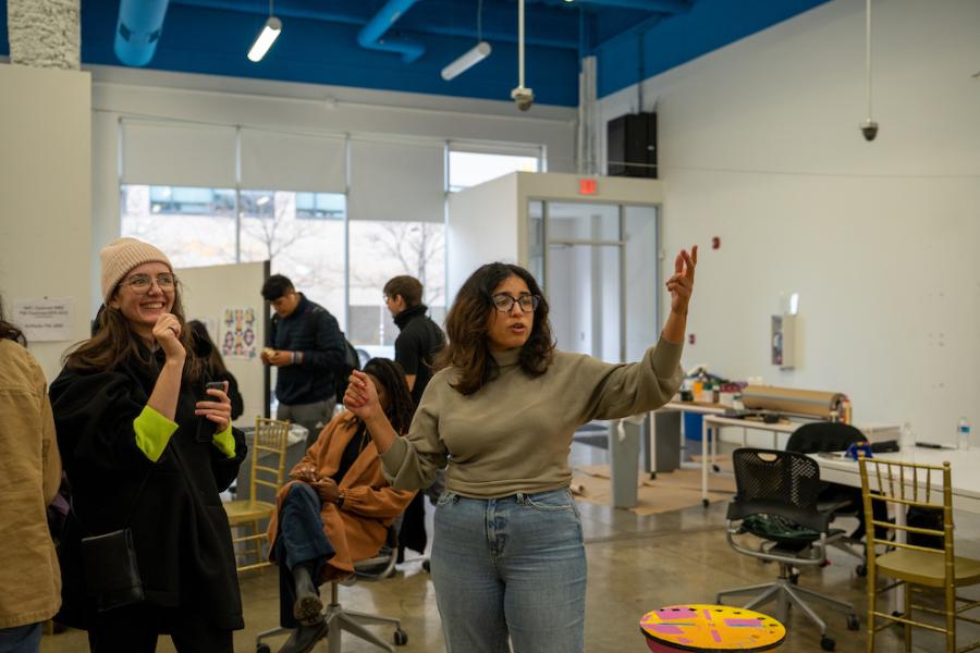 Two people at the center of a studio space