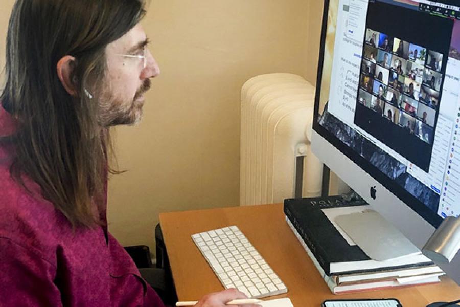 Doug McKee looking at a zoom session with his class on his computer monitor