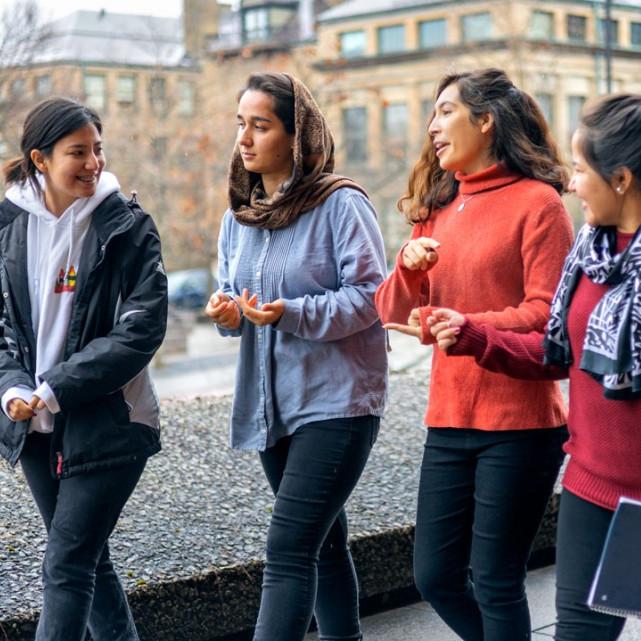 Four people walk along together