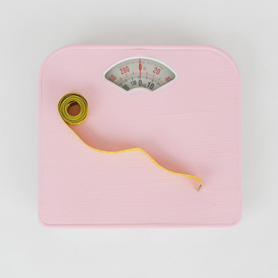 Pink bathroom scale and measuring tape