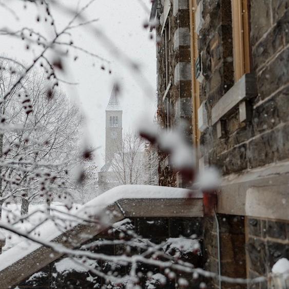 Stone building entrance, snow falling