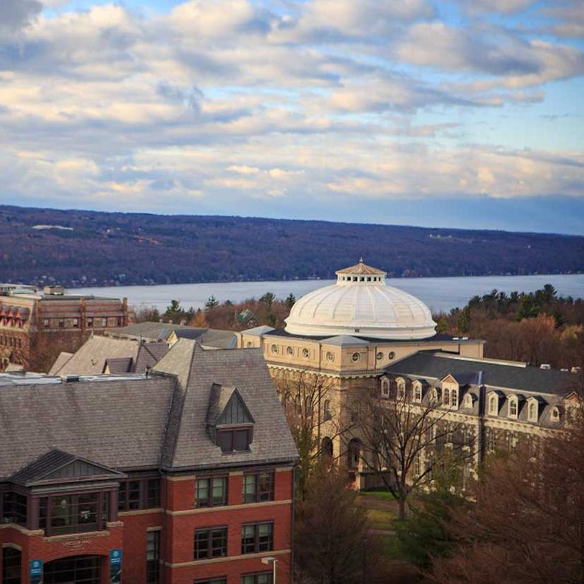 Campus buildings, cloudy sky, lake