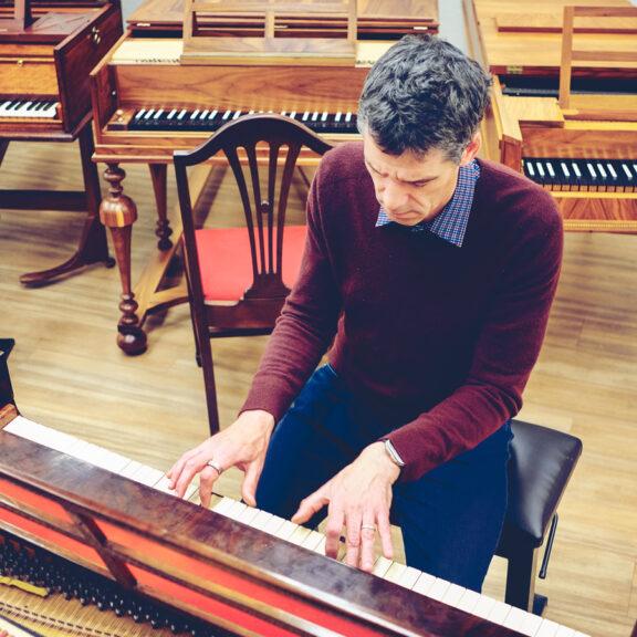 Person playing a keyboard instrument, seen from above