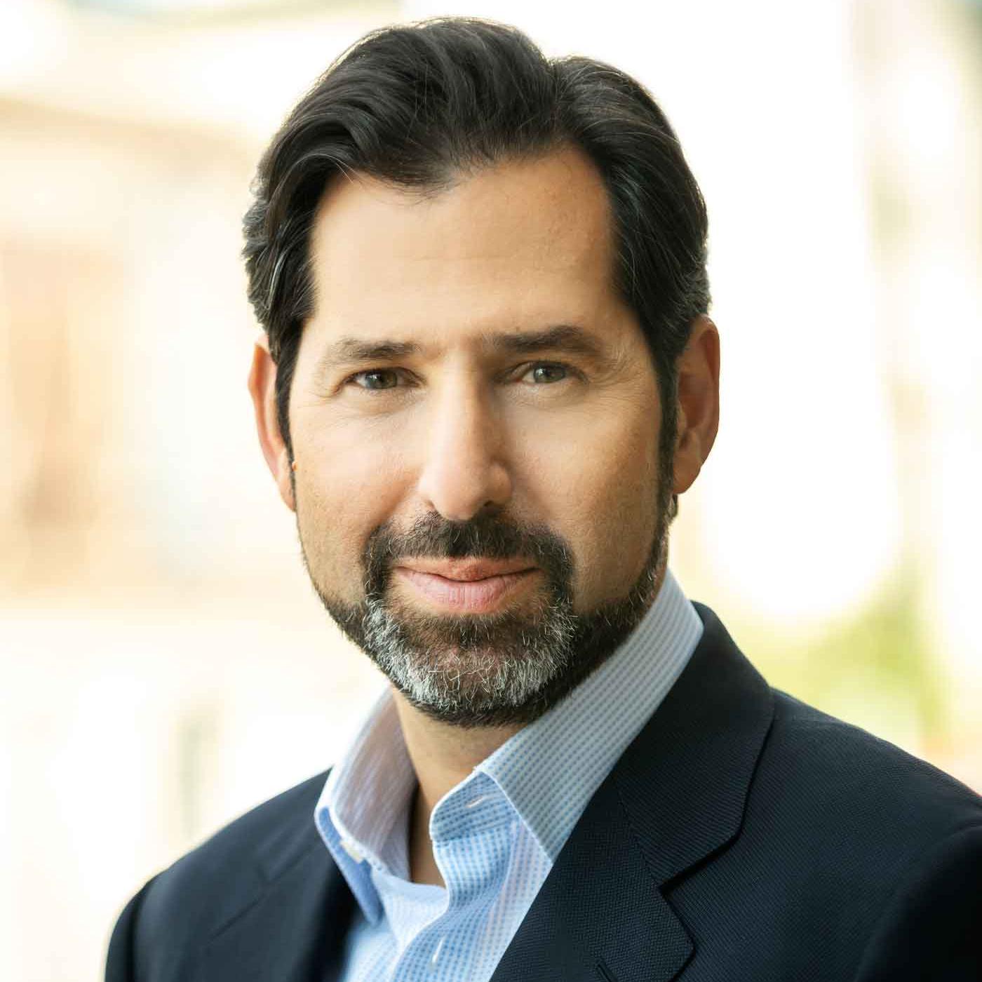 		A headshot of David Folkenflik, with black short hair and a salt and pepper beard and mustache, wearing a suite jacket.
	