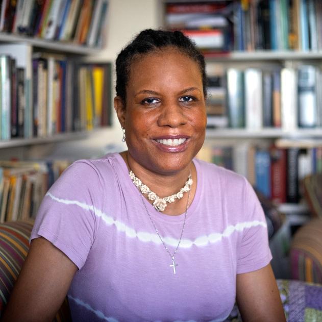 		Woman sitting in front of bookshelves
	