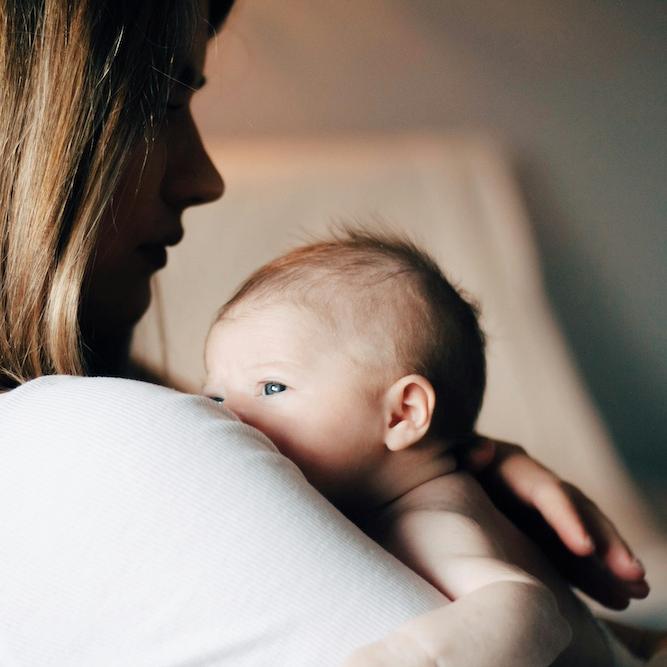 Person holding a newborn