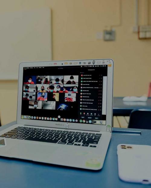 Laptop on a desk with a phone