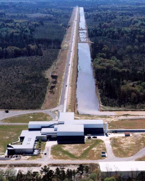 Aerial photo of white buildings at the end of a long road