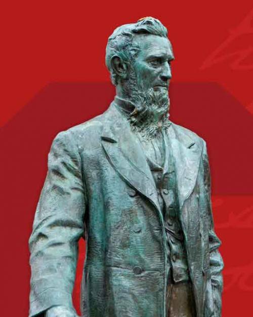 statue of Ezra Cornell against red background