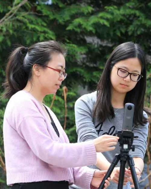 two students with video camera