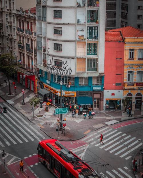 White apartment building towers over a street corner