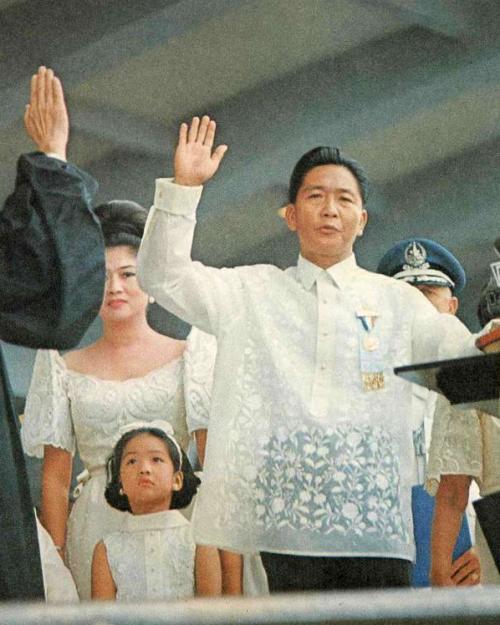 Person at a podium, hand raised to take an oath