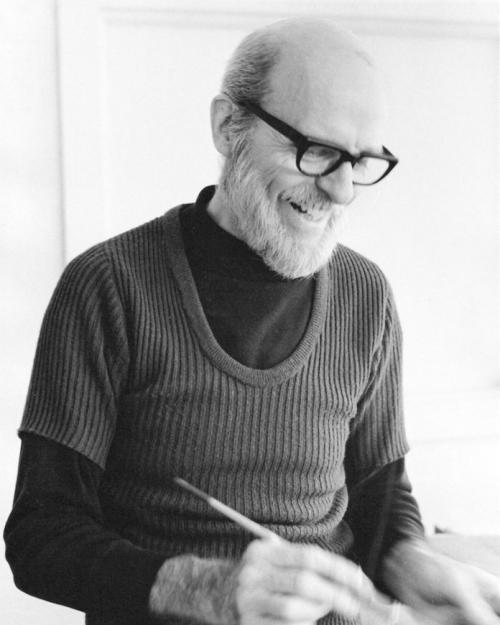 Black and white image of a man holding a paintbrush