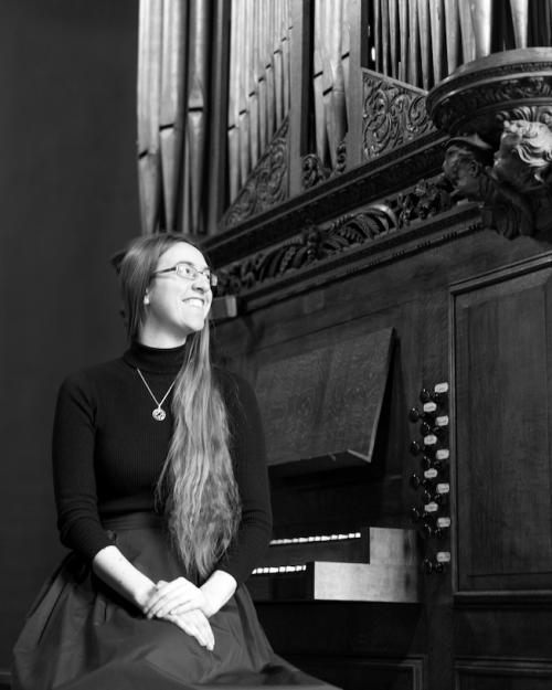 Person sitting on the bench of an organ