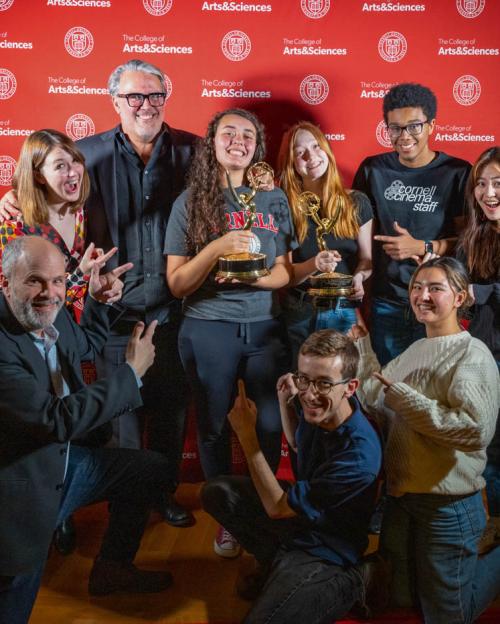 a group of people, with two holding Emmy awards