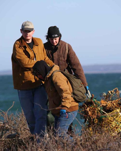 two people dragging lobster traps