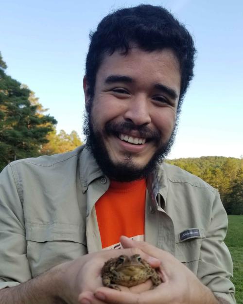 		person holding frog
	