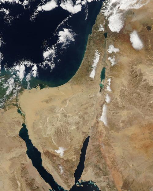 Satellite of the middle east region, seen from space: brown land, dark blue sea, highlights of snow, unusual for the region