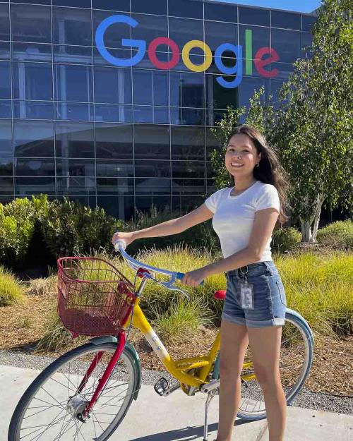a person with a bike outside a Google building