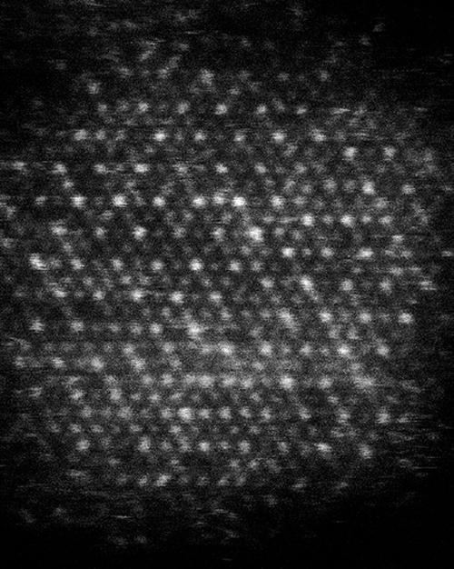 Dark background with a pattern of white dots in diagonal lines