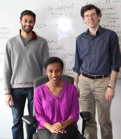  Gradstudents in front of white board.