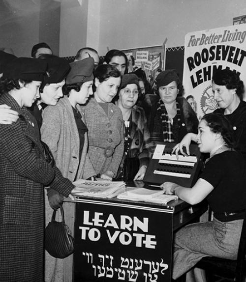  People standing around a desk, listening