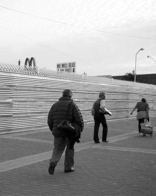  People walking along fence