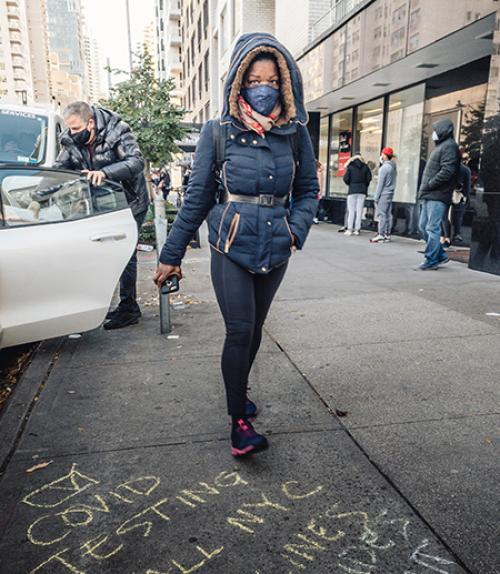  Person on city street wearing face covering